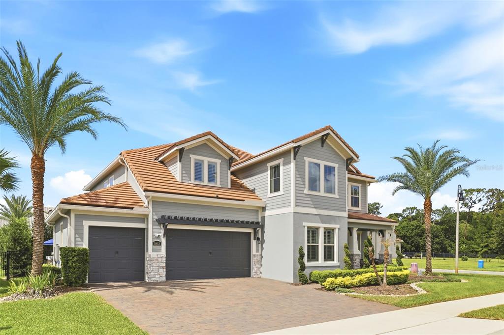 A two-story house with gray siding, a tile roof, and a paved driveway — 3851 GRASSLAND LOOP, LAKE MARY, FL