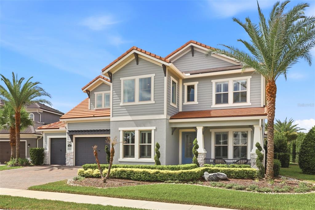 A two-story house with gray siding, a tile roof, a garage, and a front porch — 3851 GRASSLAND LOOP, LAKE MARY, FL