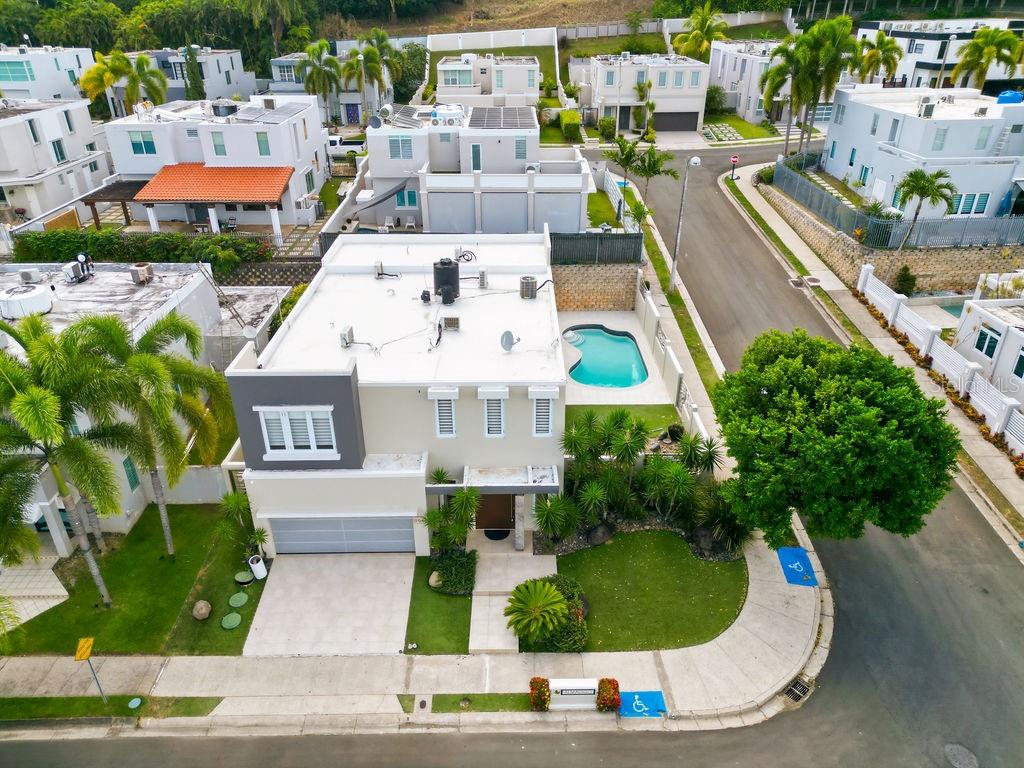 An aerial view of a two-story house with a swimming pool and a paved driveway — 366 ALMACIGO, SAN JUAN, PR