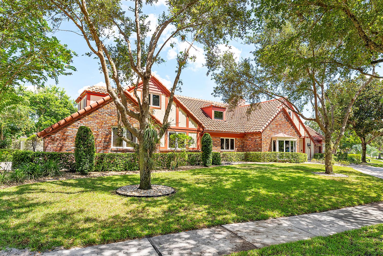 A brick and stucco house with a tiled roof sits behind a manicured lawn — 3790 Kings Way, Boca Raton FL 33434, BOCA RATON, FL
