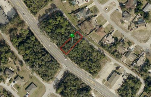 An aerial view shows a vacant, rectangular lot outlined in red next to a road — 740 FORT SMITH BOULEVARD, DELTONA, FL