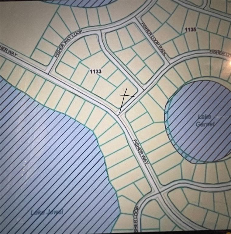 This is a map showing a residential lot marked with an X on a street — 000 FISHER LOOP, OCKLAWAHA, FL