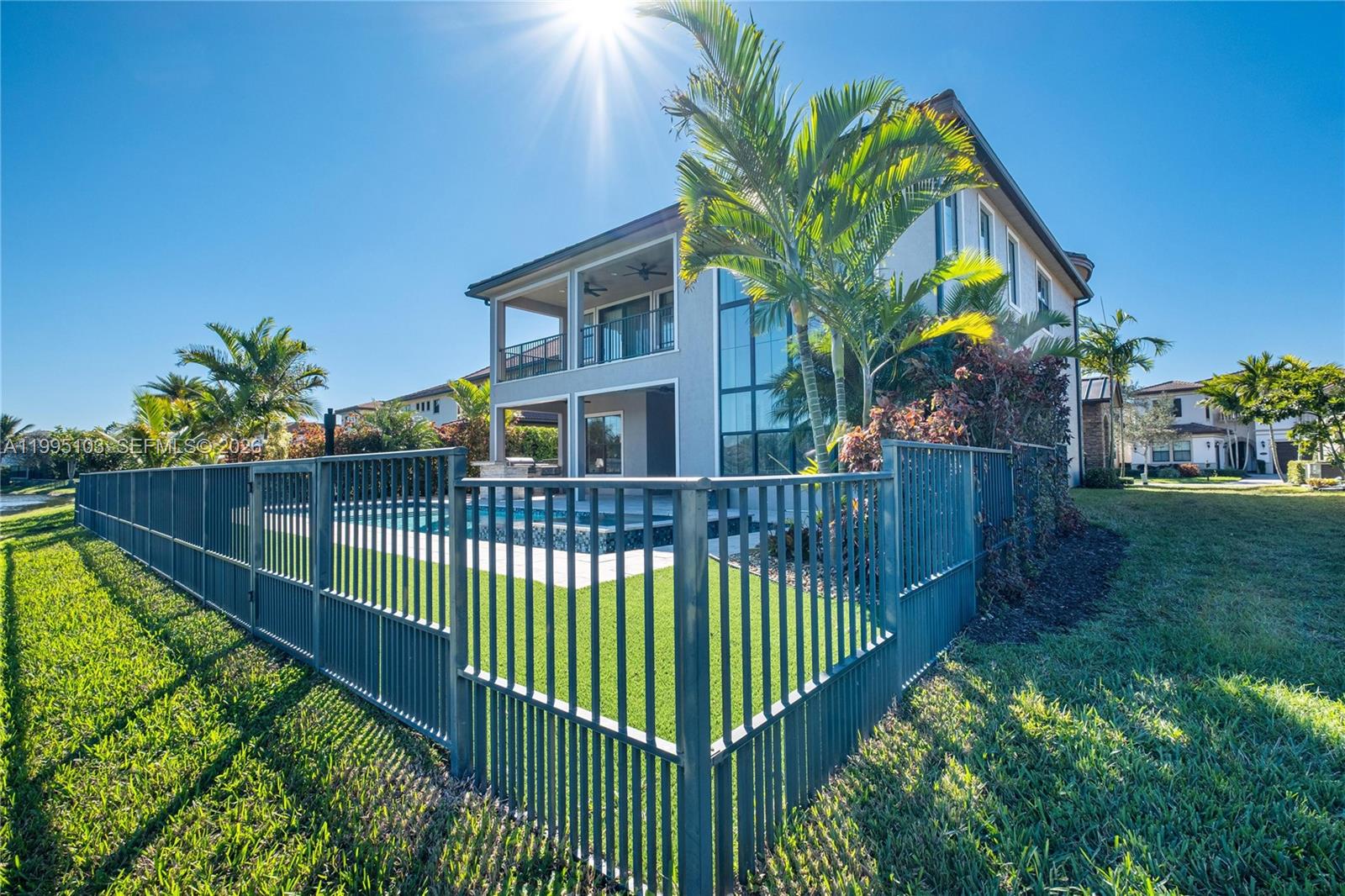 The exterior of a two-story house features a fenced backyard with a swimming pool — 11475 Watercrest Circle East, Parkland FL 33076, PARKLAND, FL