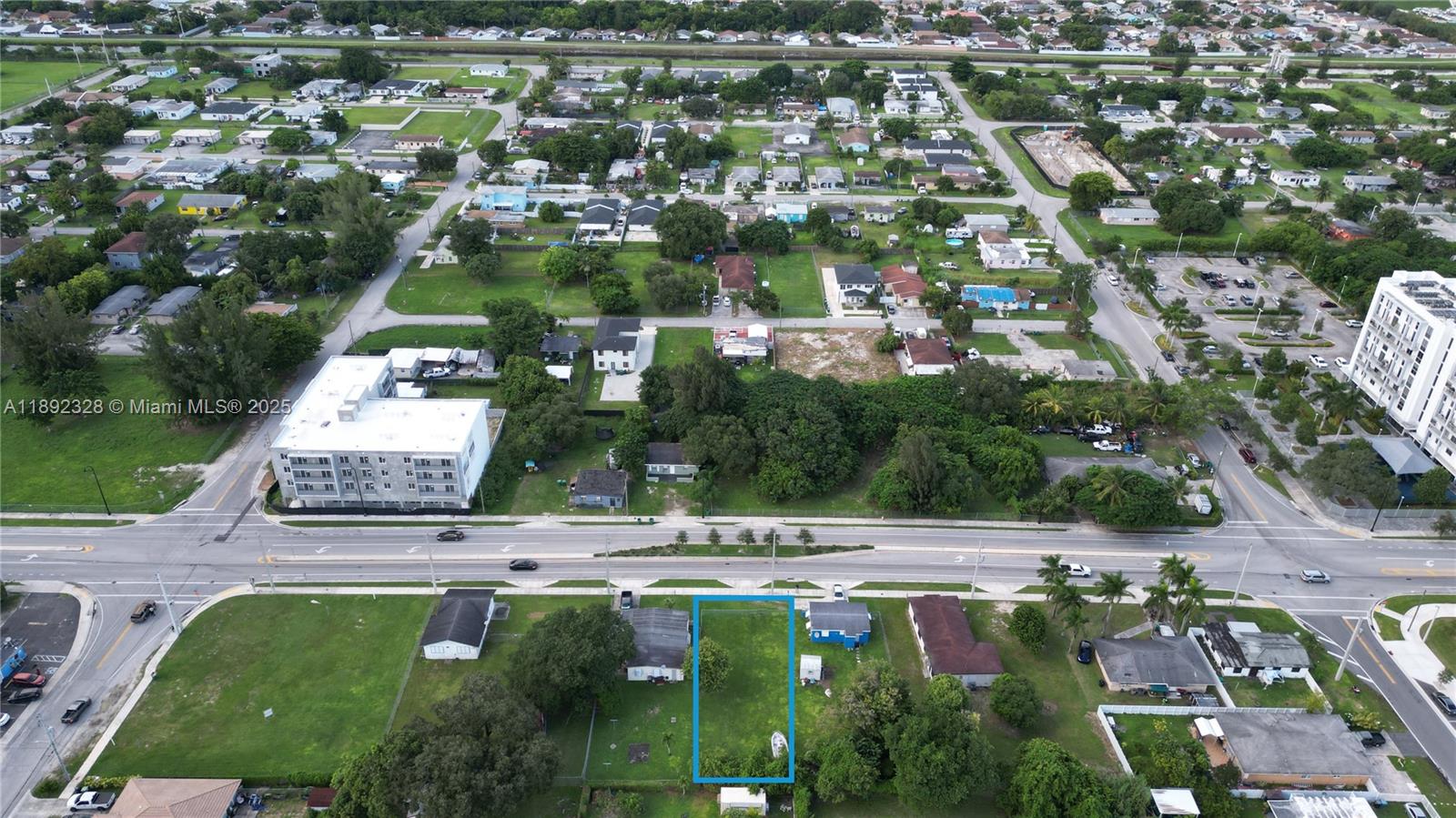 An aerial view shows a vacant rectangular lot outlined in blue within a residential neighborhood — SW, Miami FL 33170, MIAMI, FL