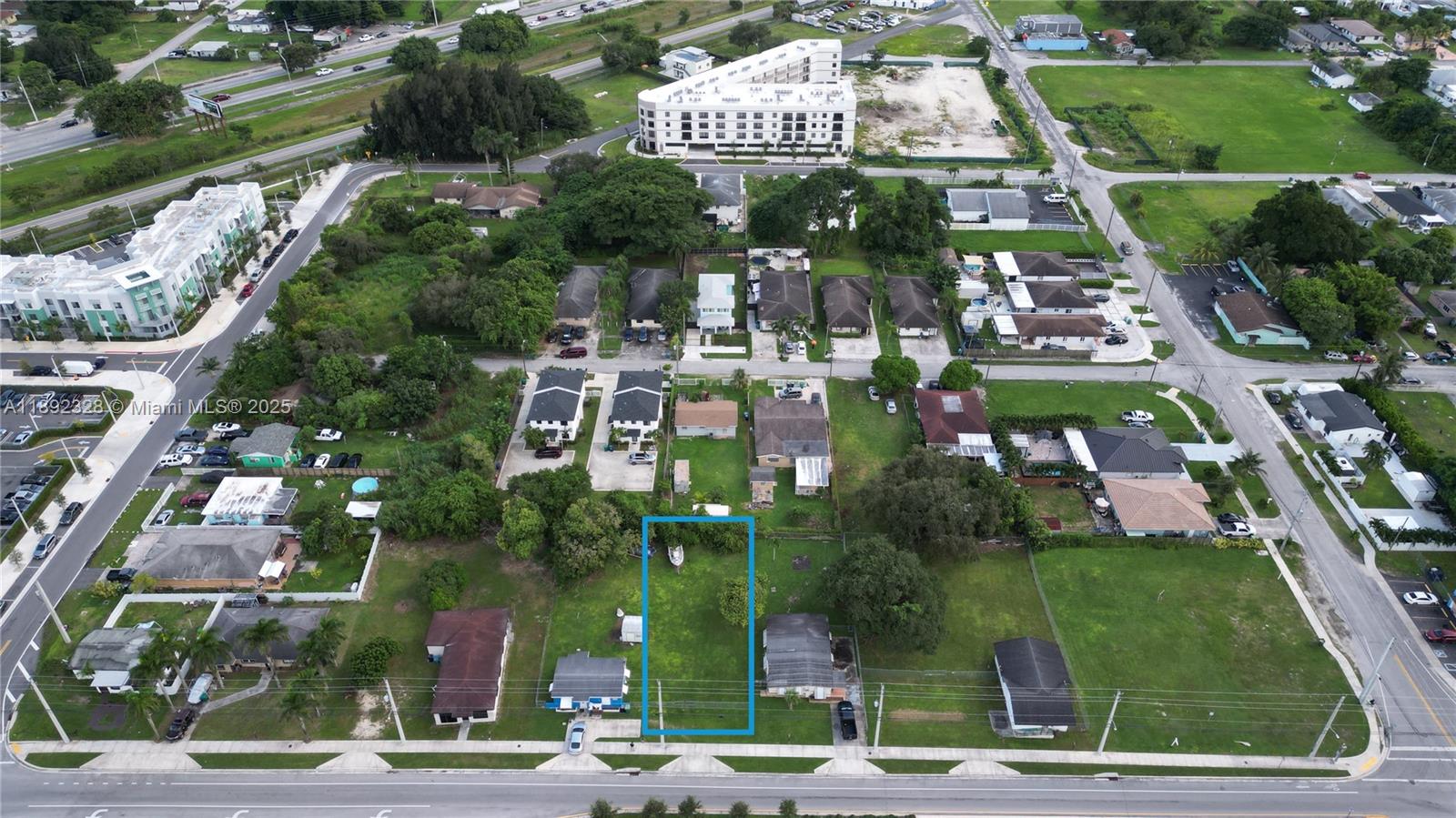 An aerial view shows a rectangular vacant lot highlighted in blue within a residential neighborhood — SW, Miami FL 33170, MIAMI, FL