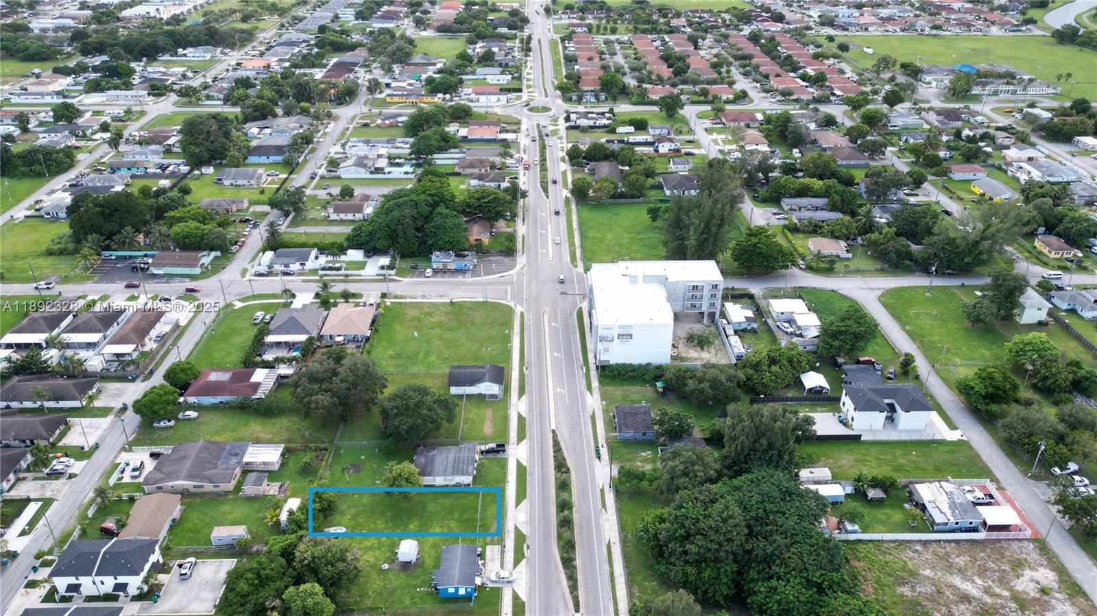 An aerial view shows a rectangular vacant lot highlighted in blue within a residential neighborhood — SW, Miami FL 33170, MIAMI, FL