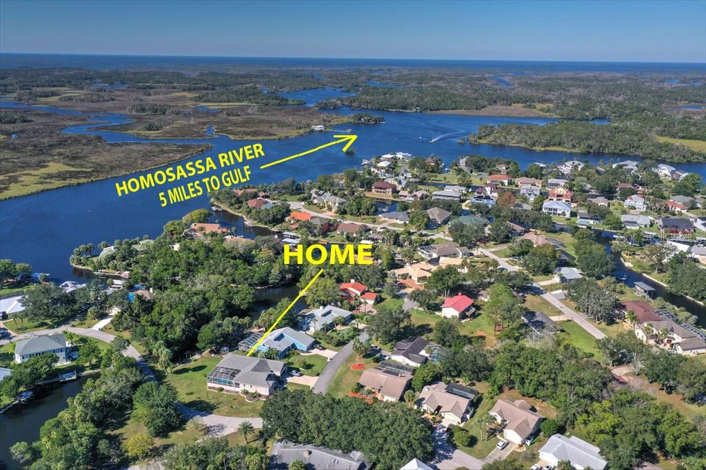 An aerial view shows a residential neighborhood near the Homosassa River and the Gulf — 11752 W VALLEY SPRING LANE, HOMOSASSA, FL