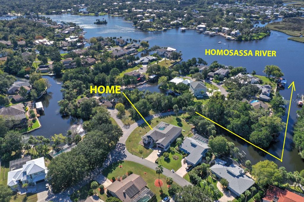 An aerial view shows a residential home situated near a canal and the Homosassa River — 11752 W VALLEY SPRING LANE, HOMOSASSA, FL