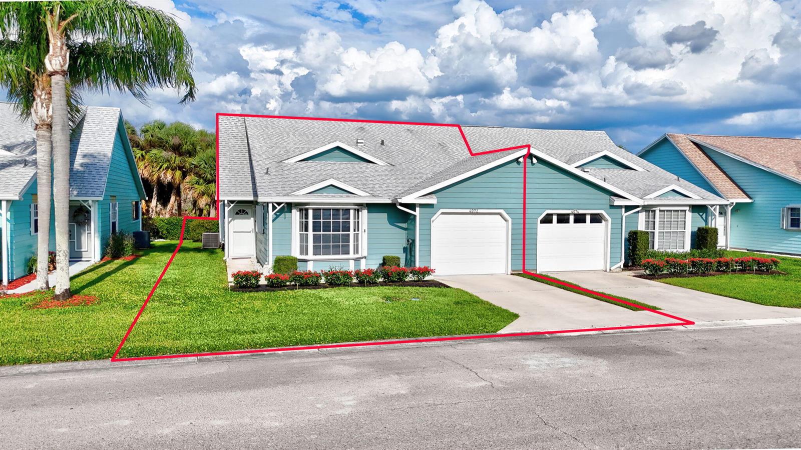 A blue single-story duplex with a white garage and a red outline highlighting the property — 4072 Gator Trace Road, Fort Pierce FL 34982, FORT PIERCE, FL
