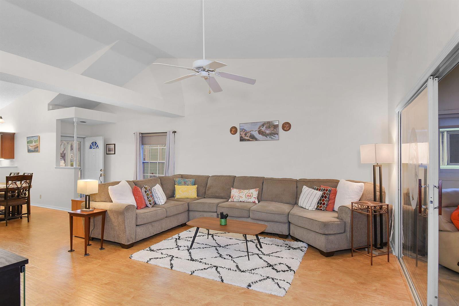 A living room with a large sectional sofa, a coffee table, and a ceiling fan — 4072 Gator Trace Road, Fort Pierce FL 34982, FORT PIERCE, FL