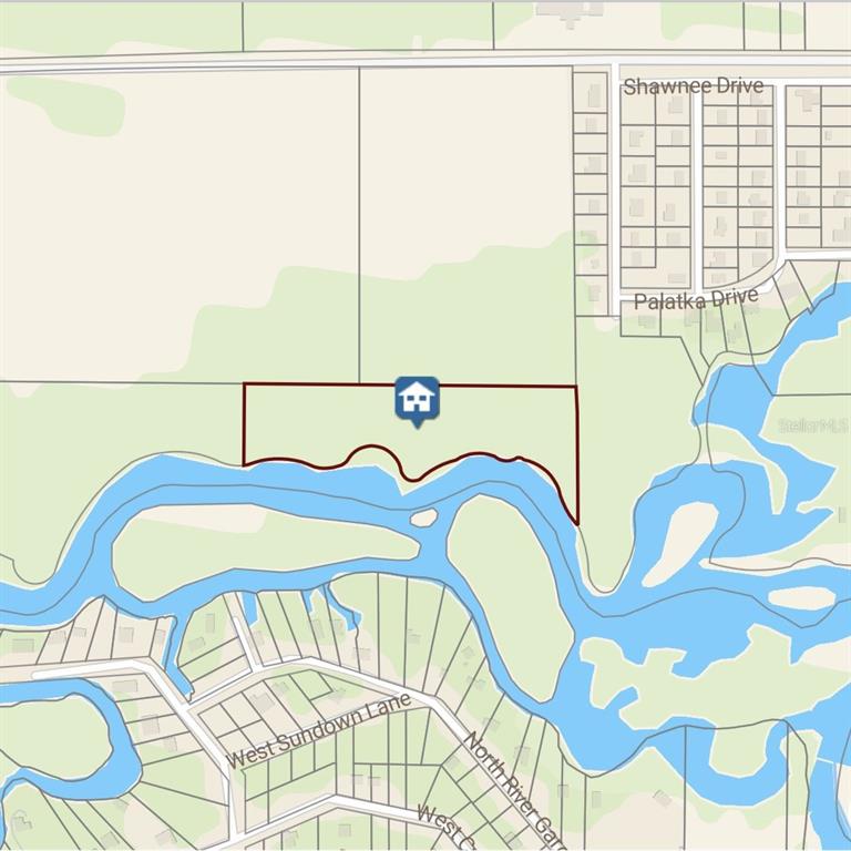 This is a map showing a property parcel highlighted in red along a river — 00 W HIGHWAY 40, DUNNELLON, FL