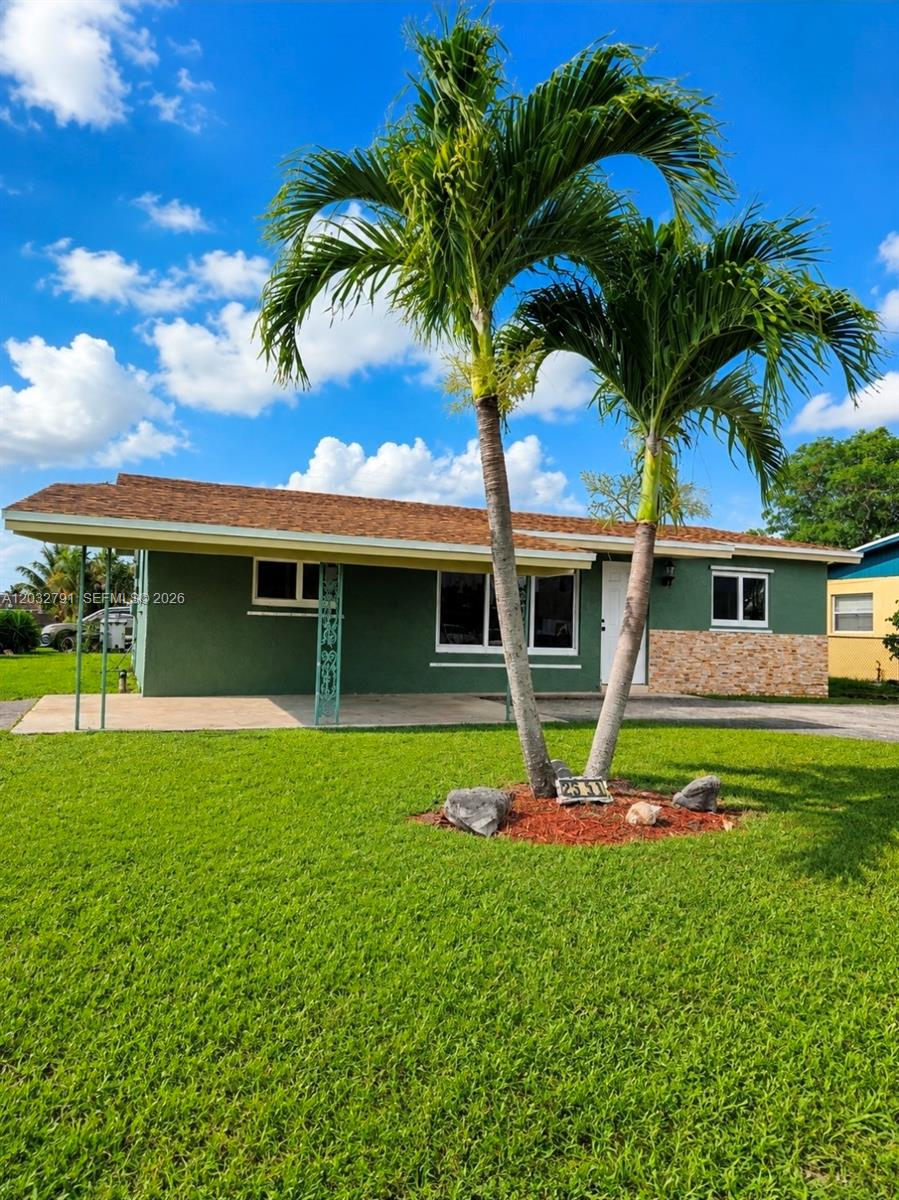 A single-story green house with a brown roof and two palm trees in the yard — 2350 NW 12th Ct # 0, Pompano Beach FL 33069, POMPANO BEACH, FL