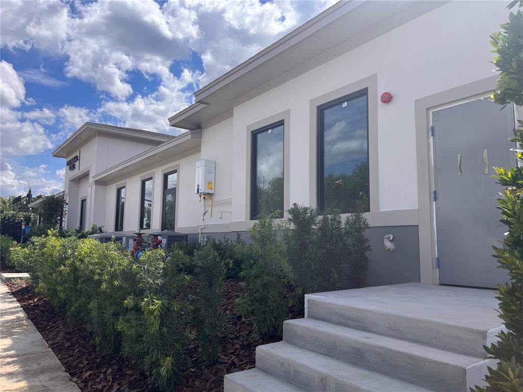A modern, single-story commercial building exterior with white walls, gray trim, and concrete steps — 370 MAPLE STREET, ALTAMONTE SPRINGS, FL