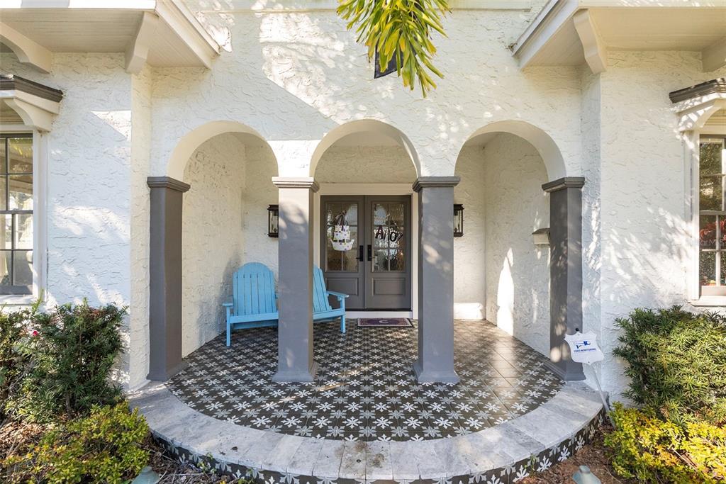 A covered front porch features three arched openings, gray columns, and patterned tile flooring — 2943 W BAYSHORE COURT, TAMPA, FL