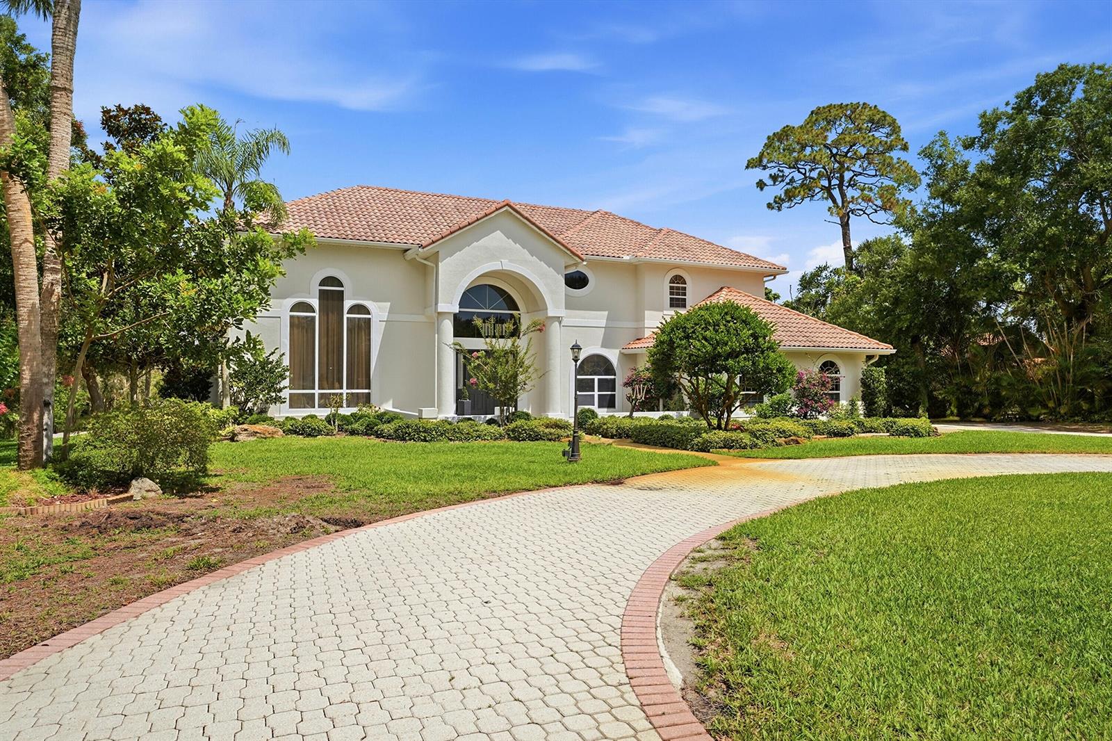 An aerial view of a two-story house with a tile roof and a circular driveway — 12765 Roseland Road, Sebastian FL 32958, SEBASTIAN, FL