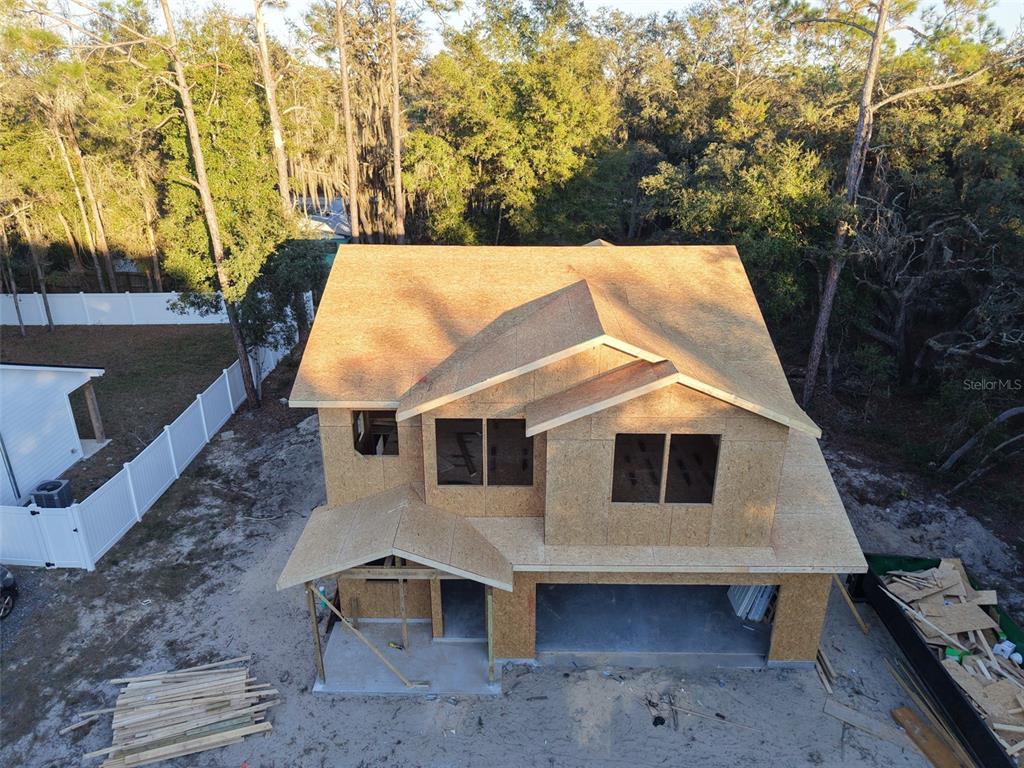 An aerial view of a two-story house under construction with plywood sheathing and a garage — 1307 OCEAN STREET, PALATKA, FL