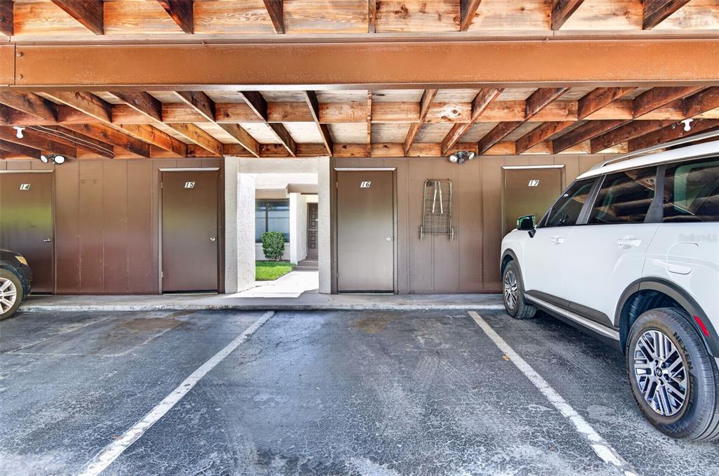 A covered parking area features numbered doors for units 14 through 17 — 2207 BELLEAIR ROAD UNIT B16, CLEARWATER, FL