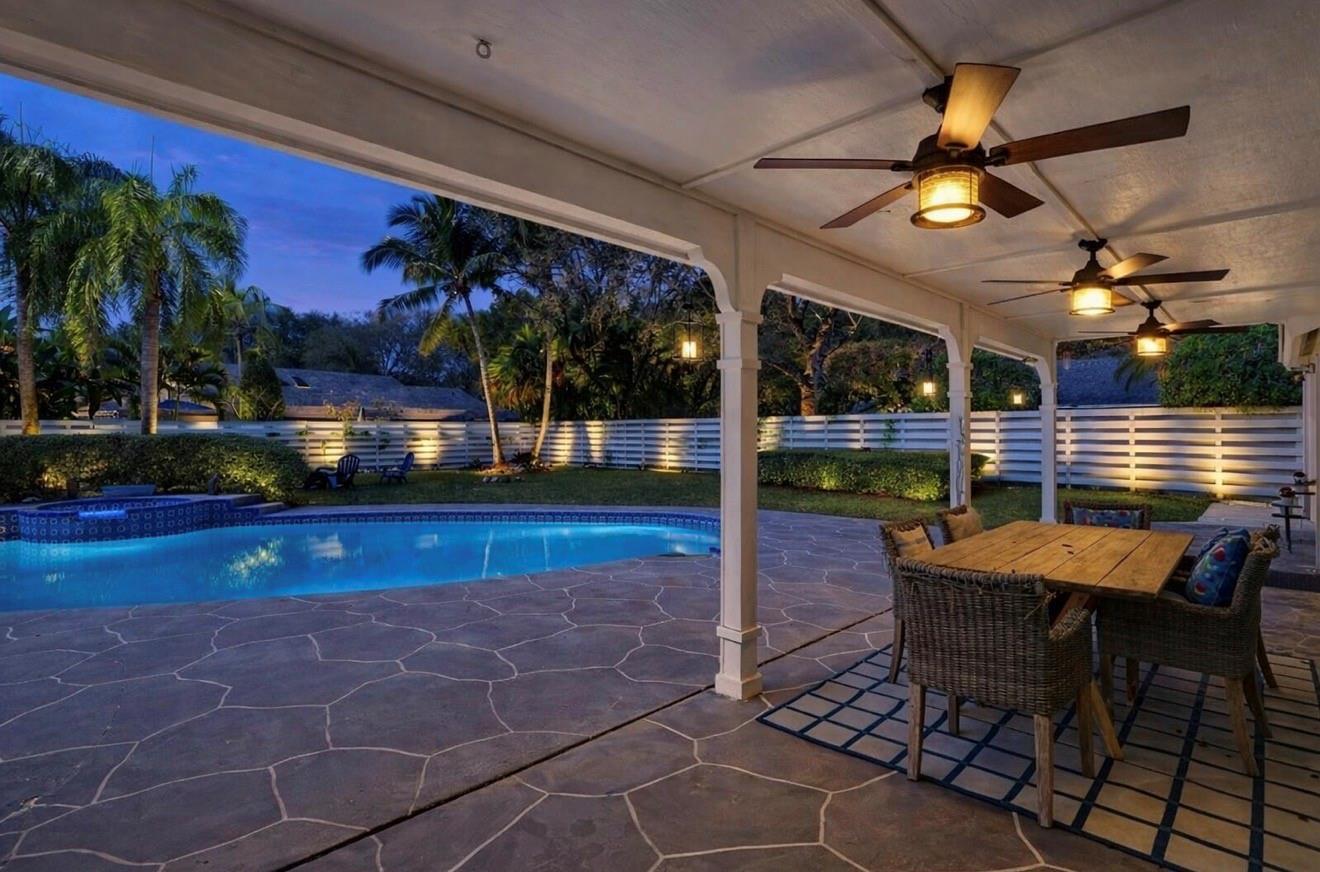 A yellow house with a brick walkway leading to a dark double-door entrance — 14930 SW 145th Street, Miami FL 33196, MIAMI, FL