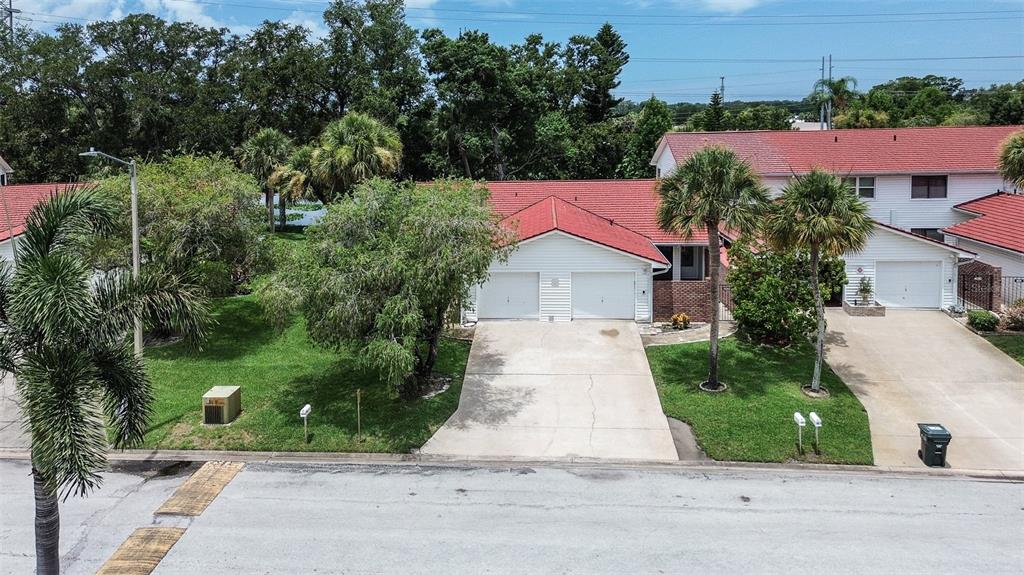 An aerial view shows two attached houses with red tile roofs and concrete driveways — 1439 WATER VIEW DRIVE W, LARGO, FL