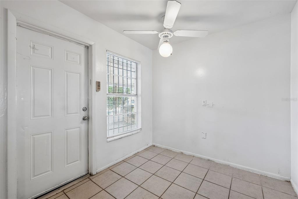 A small room with white walls, tiled flooring, a ceiling fan, and a front door — 2869 WILLOW RUN, ORLANDO, FL