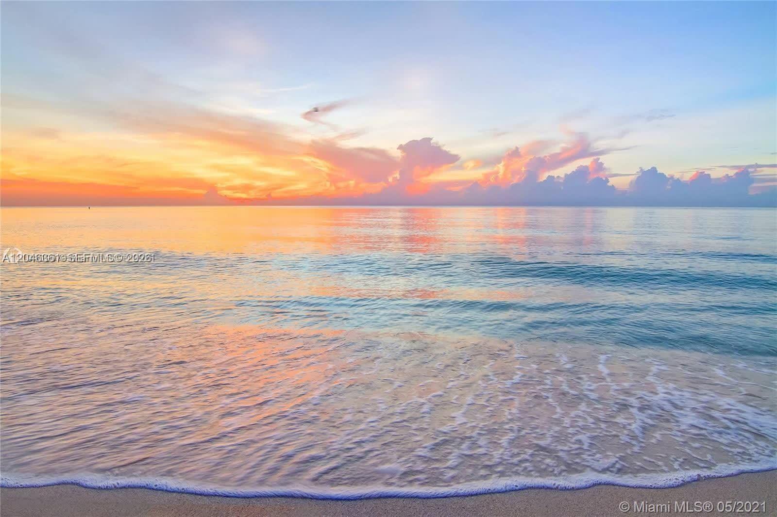 A view of the ocean waves washing onto a sandy beach at sunset — 6801 Collins Ave, Miami Beach FL 33141, MIAMI BEACH, FL