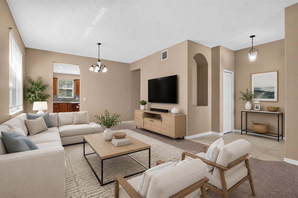 A living room with a sectional sofa, two armchairs, a television, and a coffee table — 223 LARGOVISTA DR., OAKLAND, FL