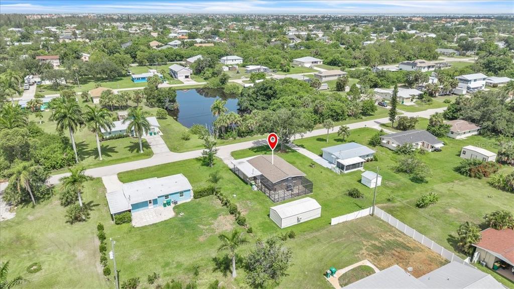 An aerial view shows a house with a screened-in patio and a detached shed — 3414 ASH STREET, PUNTA GORDA, FL