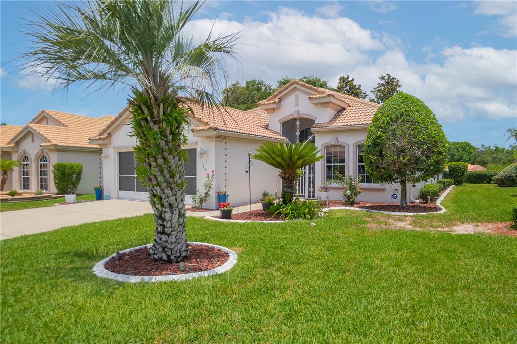 A single-story house with a tile roof, a palm tree, and a manicured lawn — 1148 W DIAMOND SHORE LOOP, HERNANDO, FL