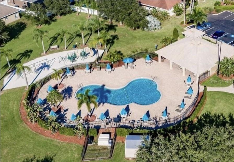 An aerial view of a community swimming pool with a pavilion and surrounding lounge chairs — 408 19TH STREET NW, RUSKIN, FL