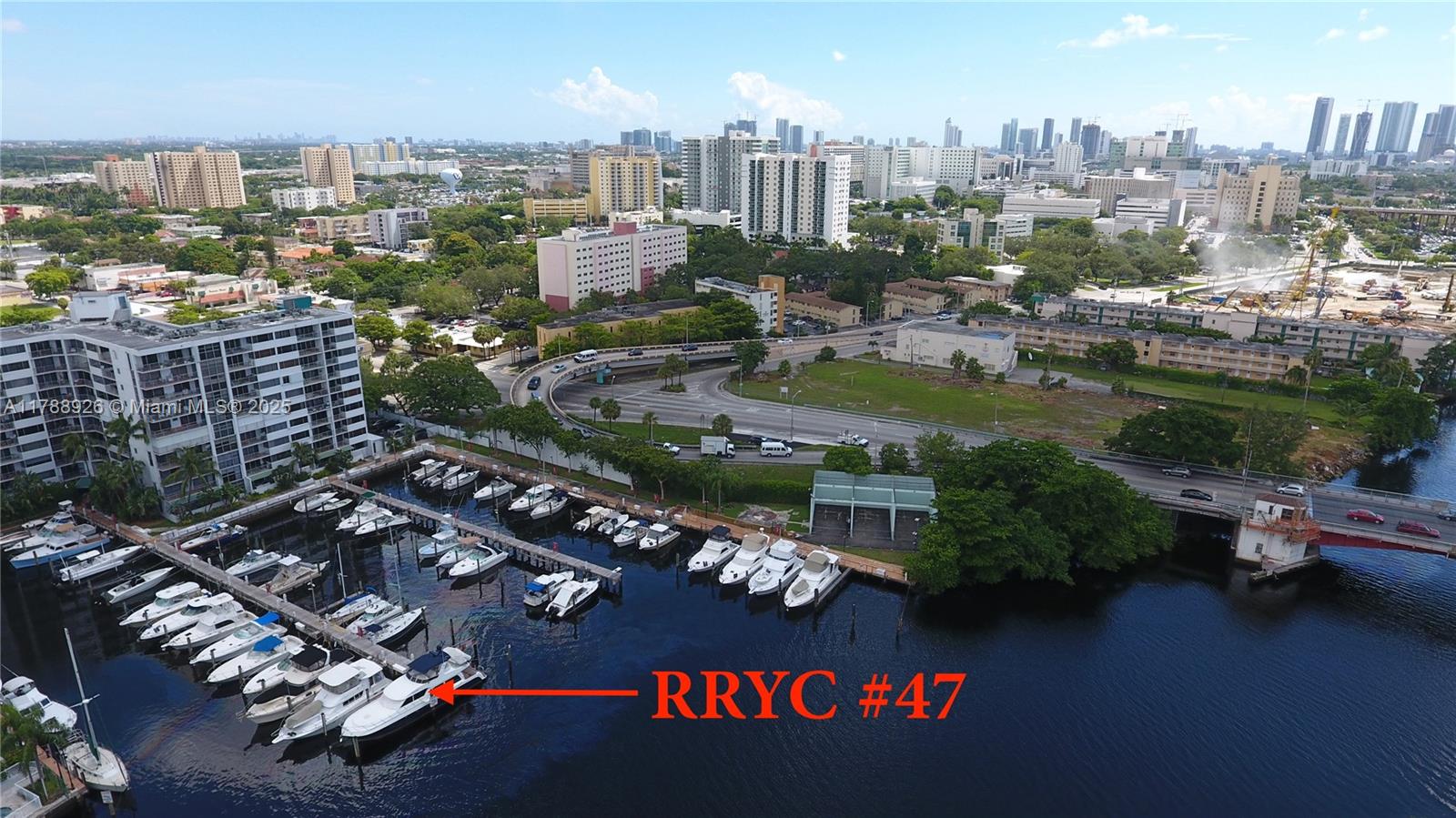 An aerial view shows a marina with multiple docked boats and a nearby highway overpass — 1700 NW N River Dr, Miami FL 33125, MIAMI, FL