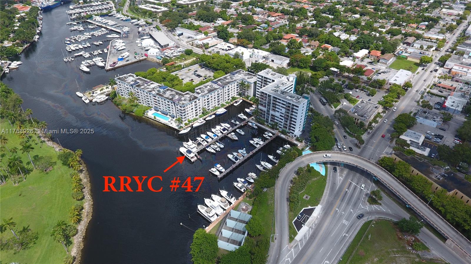 An aerial view shows a residential complex with a marina and docked boats — 1700 NW N River Dr, Miami FL 33125, MIAMI, FL