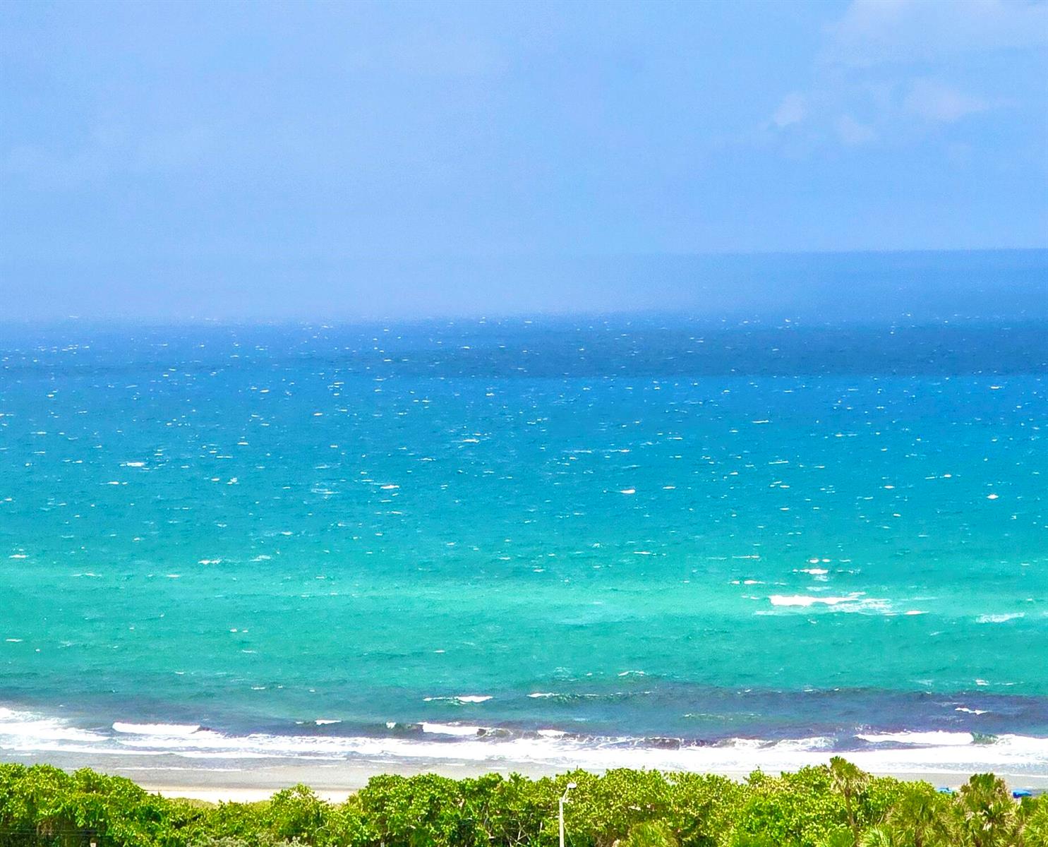 An elevated view of a sandy beach and the turquoise ocean under a clear sky — 4101 N Ocean Boulevard # 1604, Boca Raton FL 33431, BOCA RATON, FL