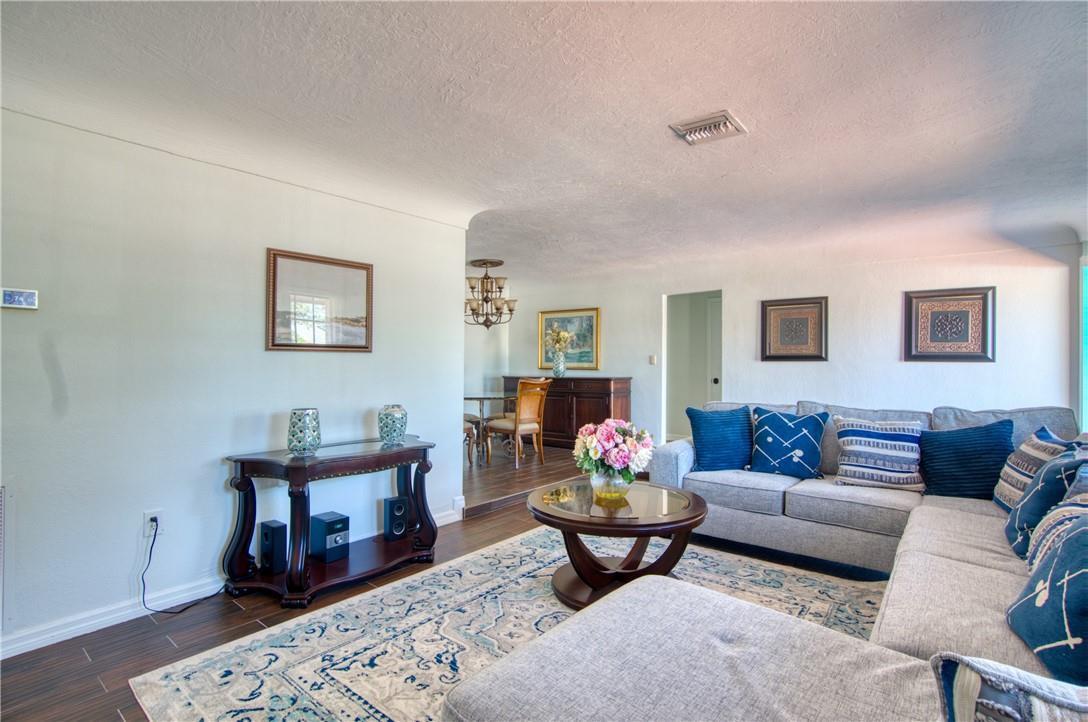 A living room with a sectional sofa, area rug, and a dining area in the background — 3513 E Shore Road, Miramar FL 33023, MIRAMAR, FL