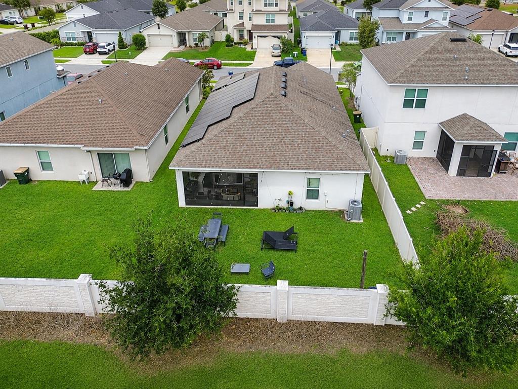 An aerial view shows the backyard and roof of a house with solar panels installed — 2975 PARKFIELD ROAD, ST CLOUD, FL