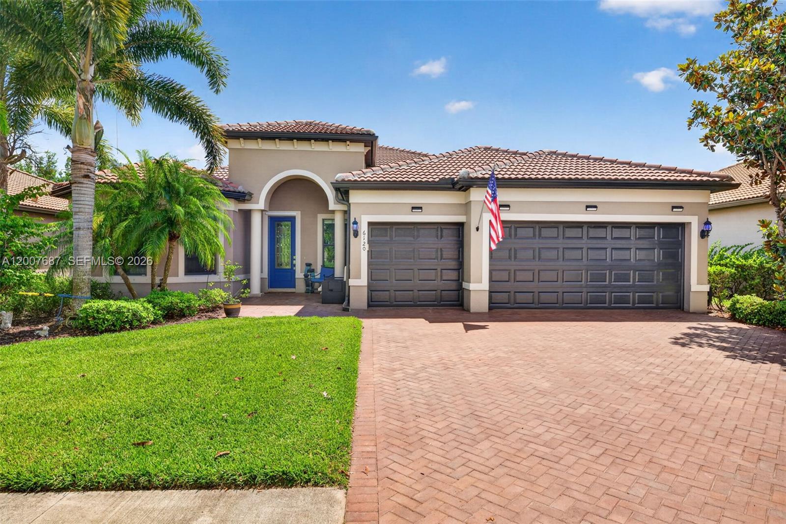 A sunroom features a hot tub, white armchairs, and a view of a golf course — 6120 Victory Dr, Ave Maria FL 34142, AVE MARIA, FL