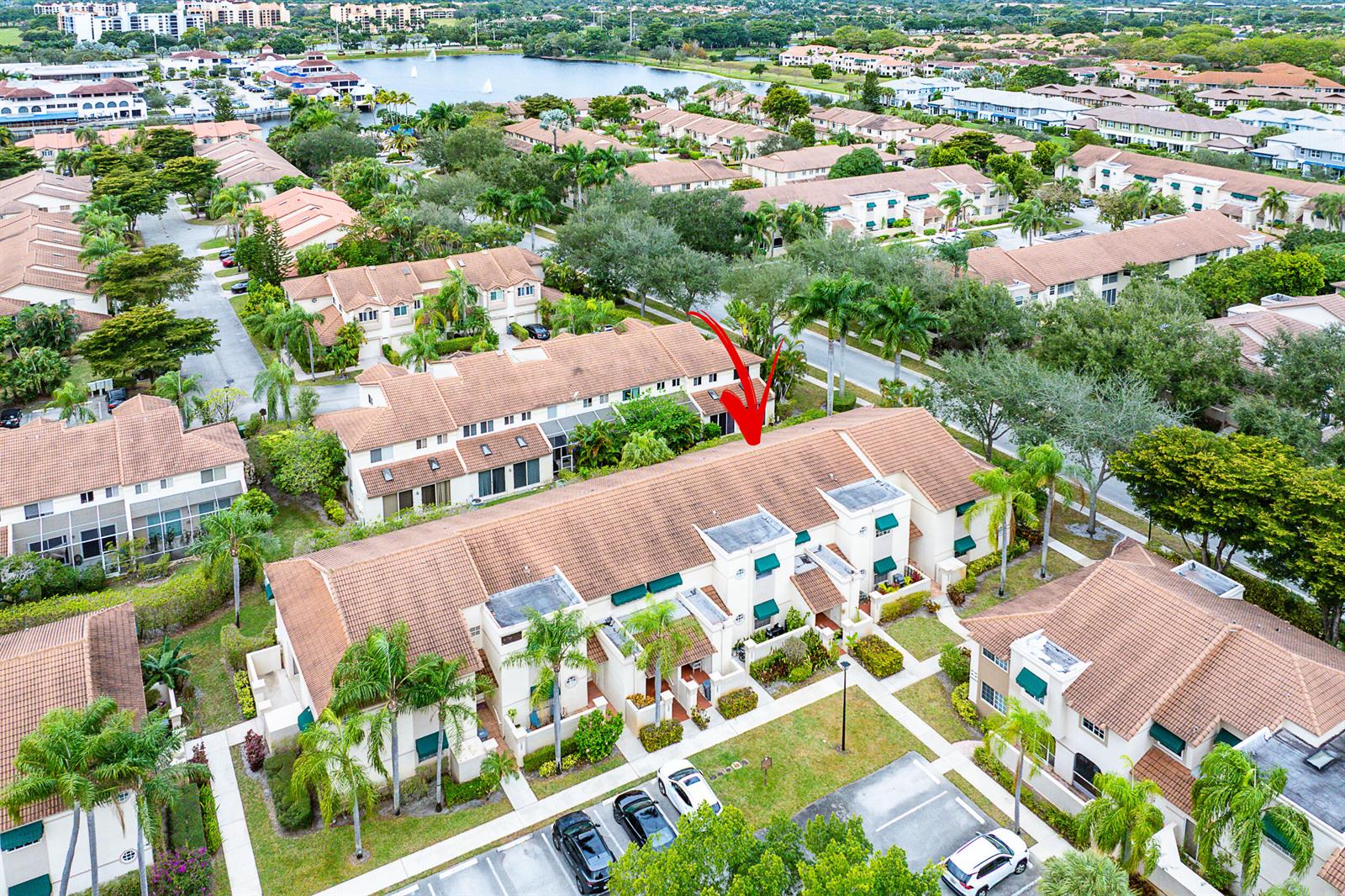 An open-concept living and dining area features tile flooring, a vaulted ceiling, and a kitchen — 6626 Via Regina, Boca Raton FL 33433, BOCA RATON, FL