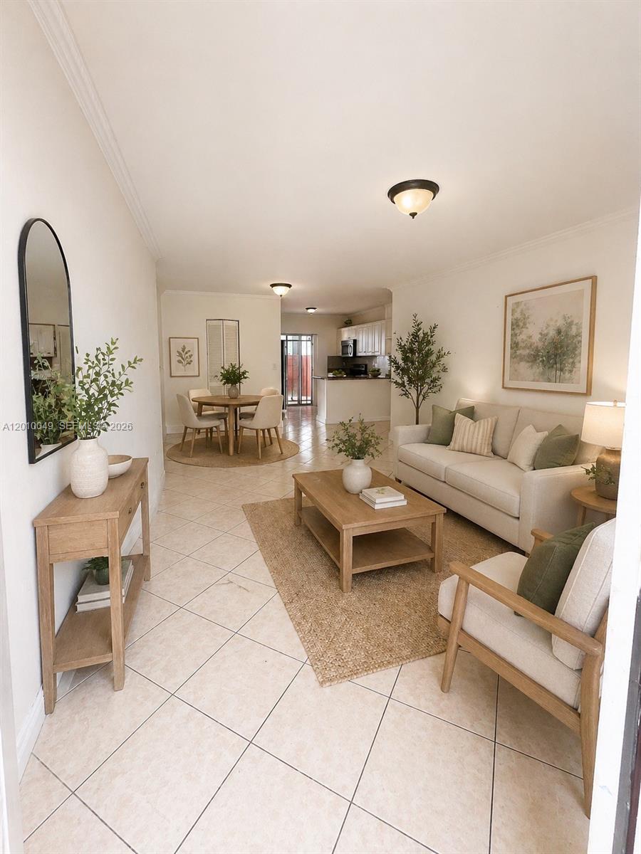This open-concept living and dining area features tile flooring, neutral furniture, and light wood accents — 11051 W Okeechobee Rd # 101, Miami FL 33018, MIAMI, FL