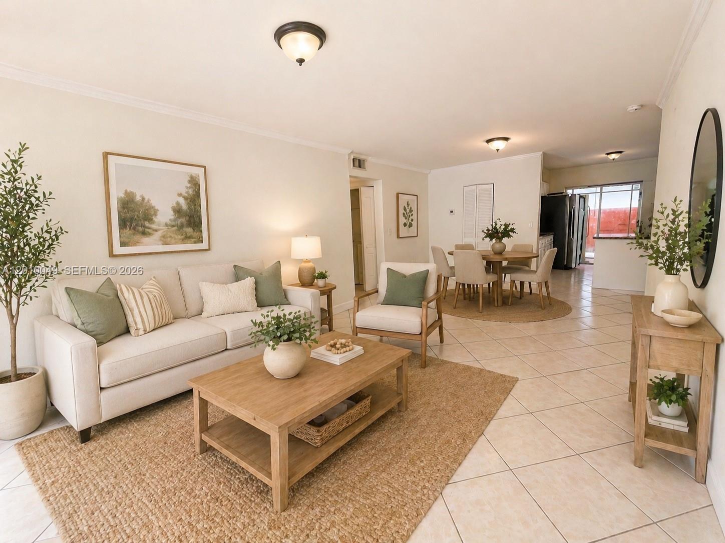 A living room and dining area feature light-colored tile floors, neutral furniture, and area rugs — 11051 W Okeechobee Rd # 101, Miami FL 33018, MIAMI, FL