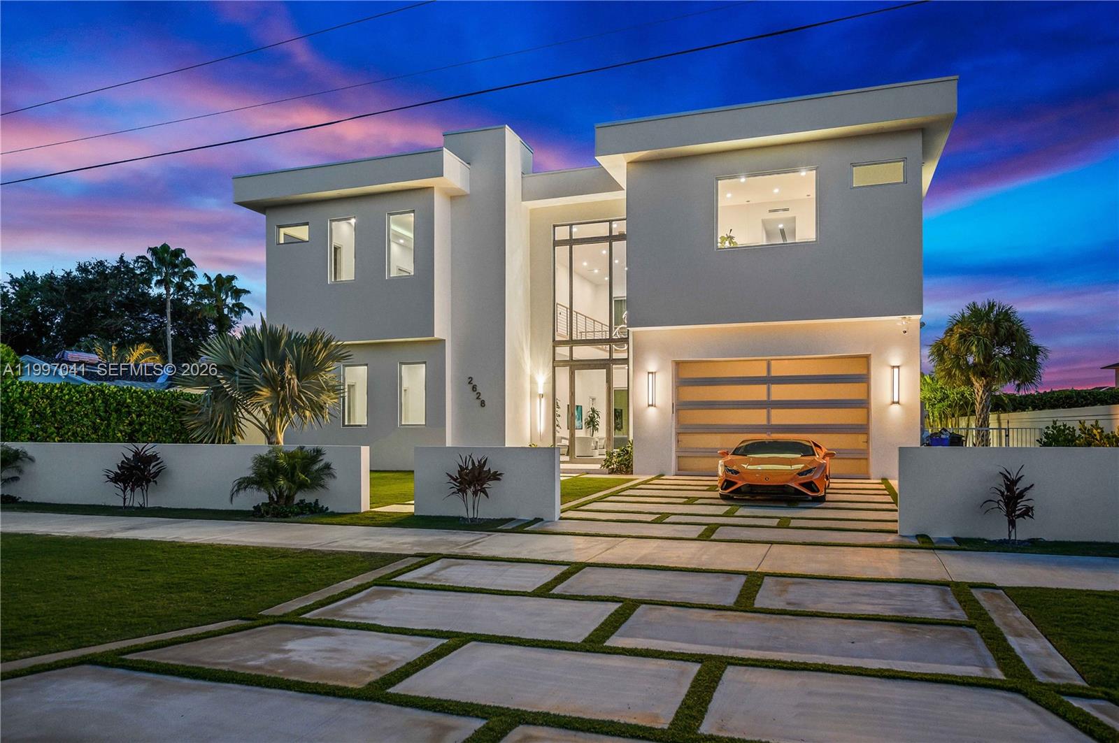 A modern two-story house with a white exterior, a garage, and an orange sports car — 2628 Marcinski Rd, Jupiter FL 33477, JUPITER, FL