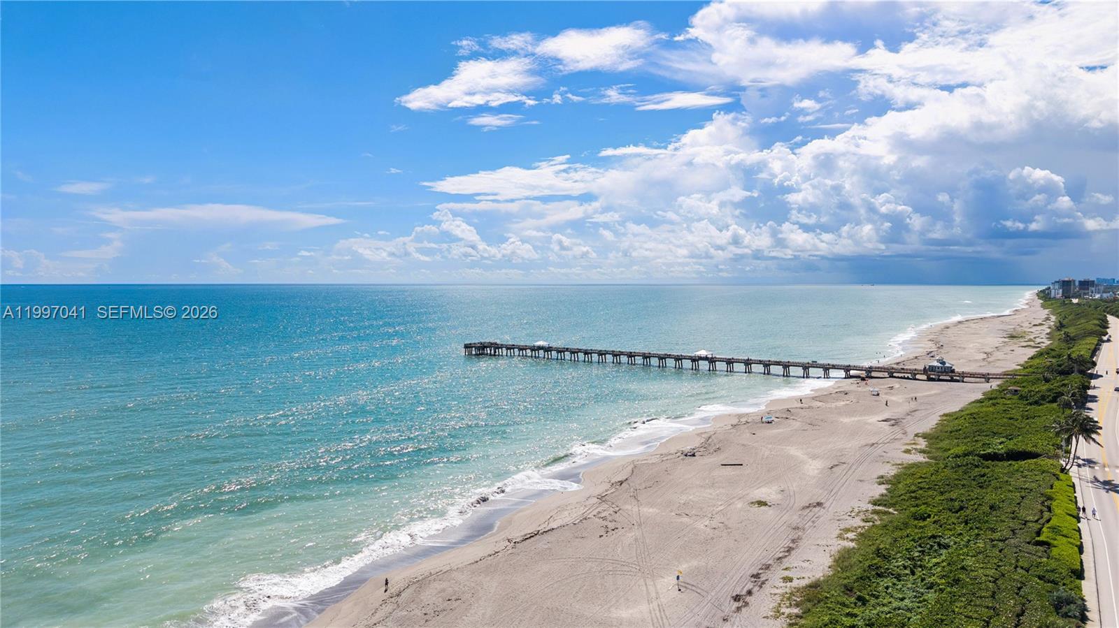 An aerial view shows a long fishing pier extending into the ocean from a sandy beach — 2628 Marcinski Rd, Jupiter FL 33477, JUPITER, FL