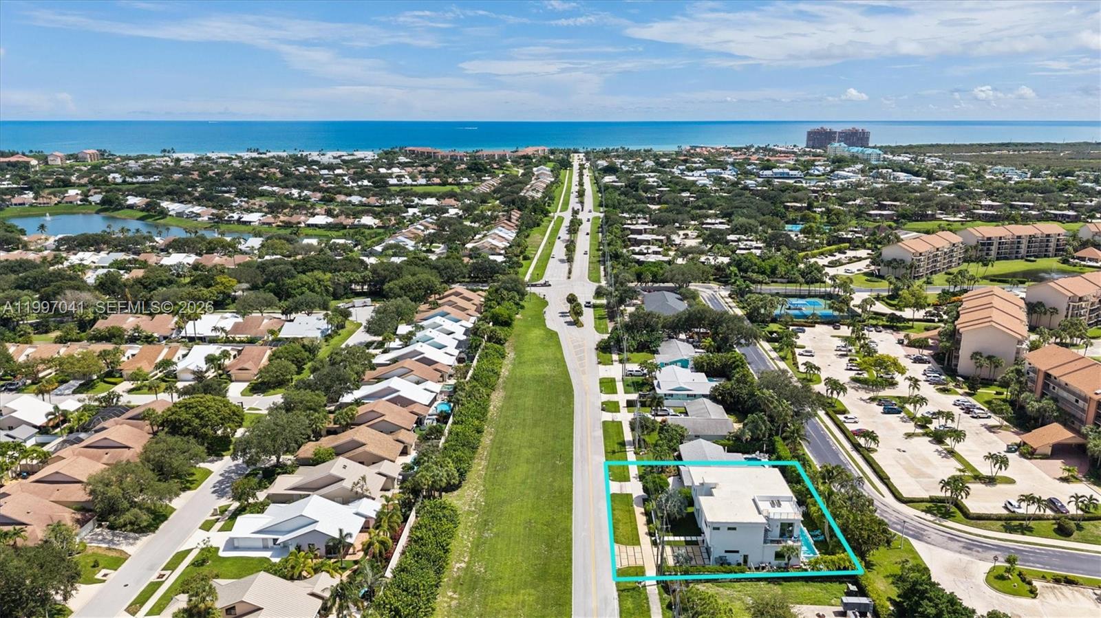 An aerial view shows a white two-story house highlighted by a teal border — 2628 Marcinski Rd, Jupiter FL 33477, JUPITER, FL