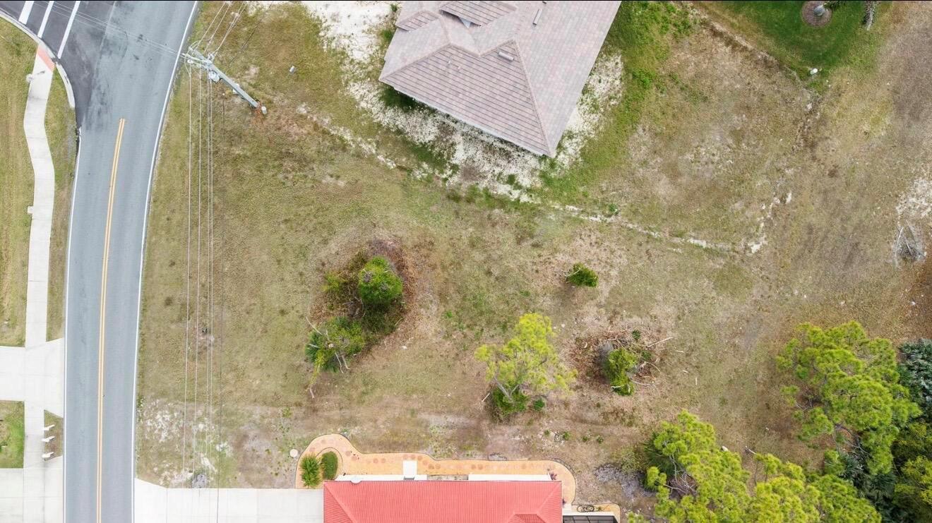 An aerial view shows a residential lot with trees, a paved road, and two houses — 4270 Cape Haze Dr Drive, FL 33946, FL