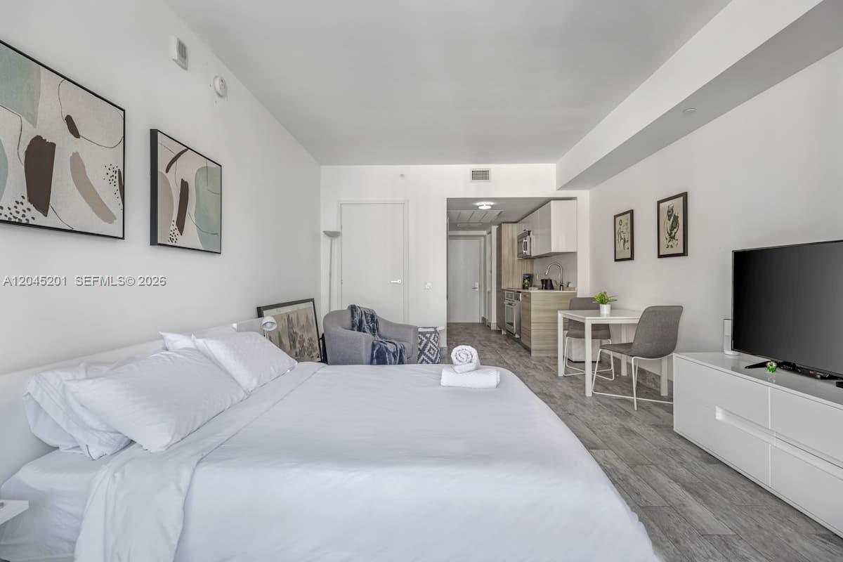 A studio apartment features a bed, a small dining area, and a kitchenette — 1300 Brickell Bay Dr # 2713, Miami FL 33131, MIAMI, FL