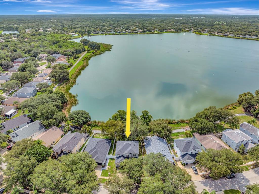 An aerial view shows a residential house with a yellow arrow pointing toward the roof — 6818 WATERTON DRIVE, RIVERVIEW, FL