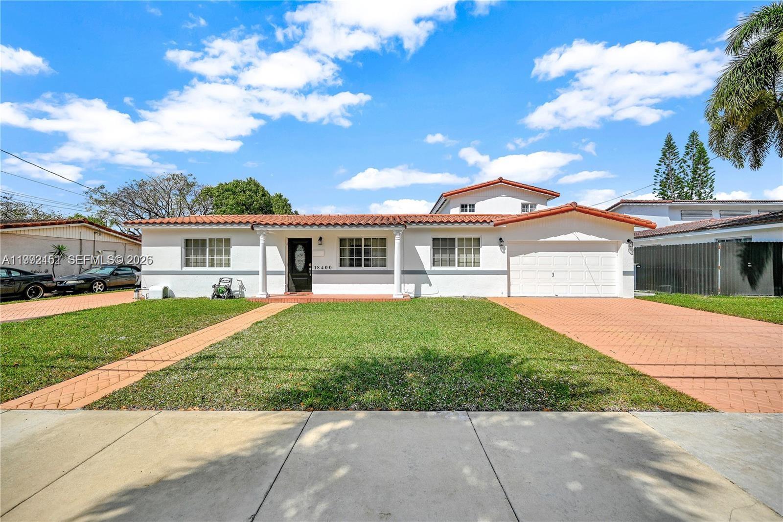A single-story white house with a red tile roof and a paved driveway — 18400 NW 78th Ave, Hialeah FL 33015, HIALEAH, FL