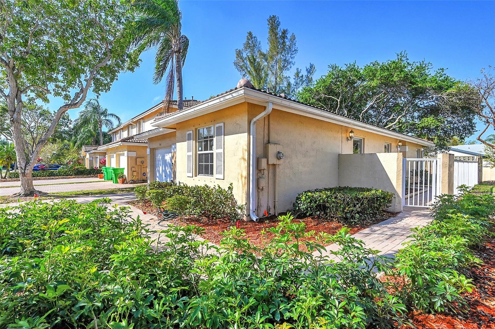 A tan stucco townhouse with a tile roof, white shutters, and a brick walkway — 5361 NW 90th Avenue, Sunrise FL 33351, SUNRISE, FL