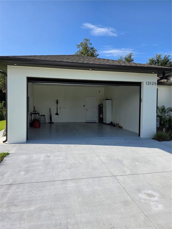 This is a floor plan of a single-story home with three bedrooms and a garage — 12125 MADRID AVENUE, NORTH PORT, FL