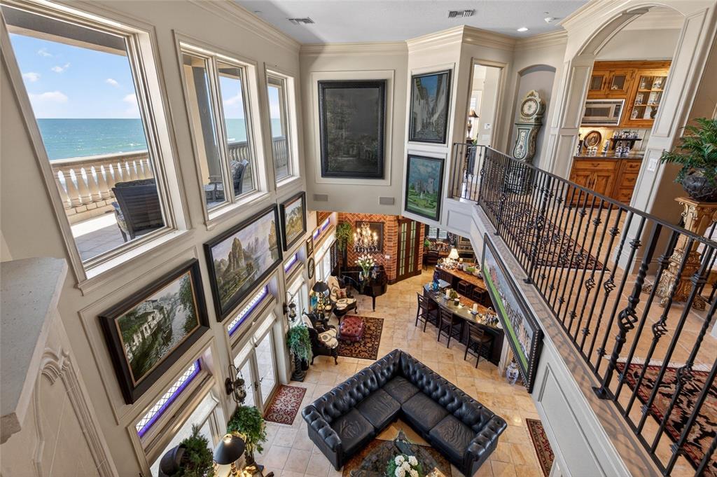 A high-angle view of a two-story living room with ocean views and a wet bar — 35 CALLE DEL SUR, PALM COAST, FL
