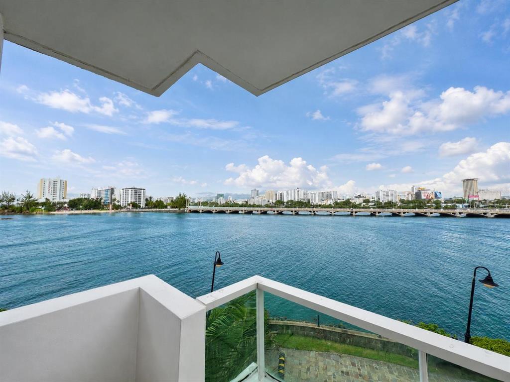 A studio apartment features a bed, sofa, marble floors, and a balcony overlooking the water — 1 CALLE SAN GERONIMO UNIT 319, SAN JUAN, PR