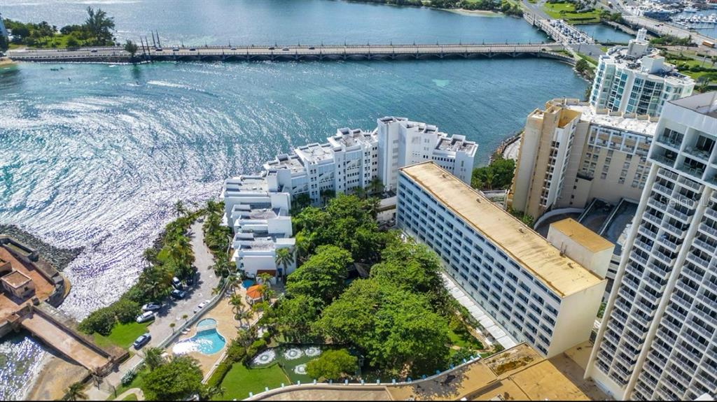 A balcony view overlooking a body of water with a city skyline in the distance — 1 CALLE SAN GERONIMO UNIT 319, SAN JUAN, PR